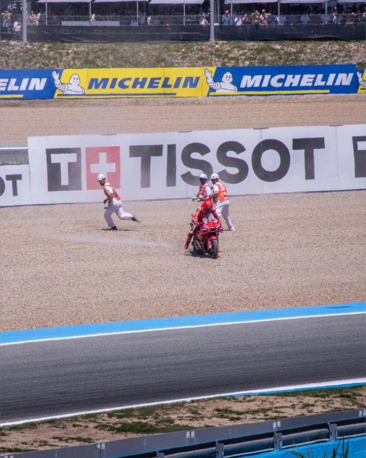 Marc Marquez recovering from a fall into the gravel