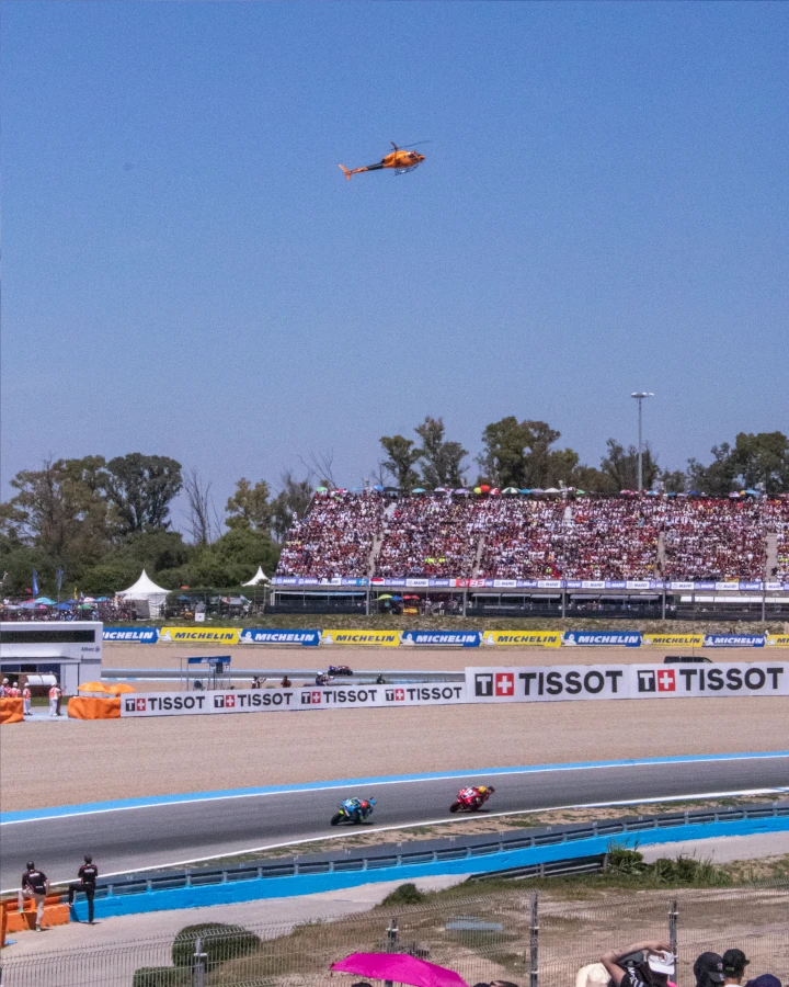 Moto GP race with helicopter in frame