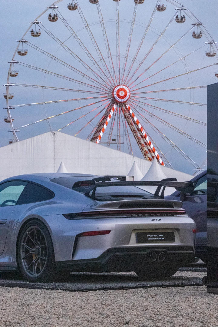 Porsche GT3 with a ferris wheel in the background